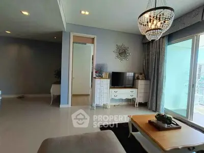 Elegant living room with chandelier and balcony access