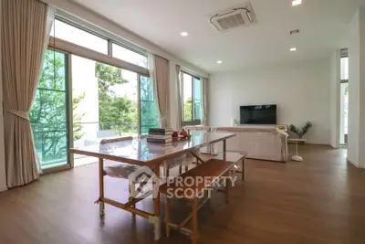 Spacious modern living room with large windows and natural light