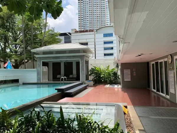 Luxurious poolside area with modern amenities in urban setting, perfect for relaxation and leisure.