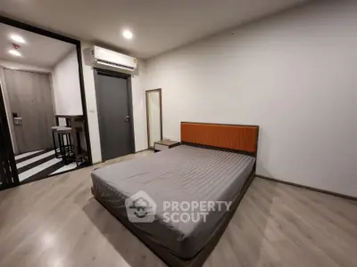 Spacious modern bedroom with minimalist design and wooden flooring