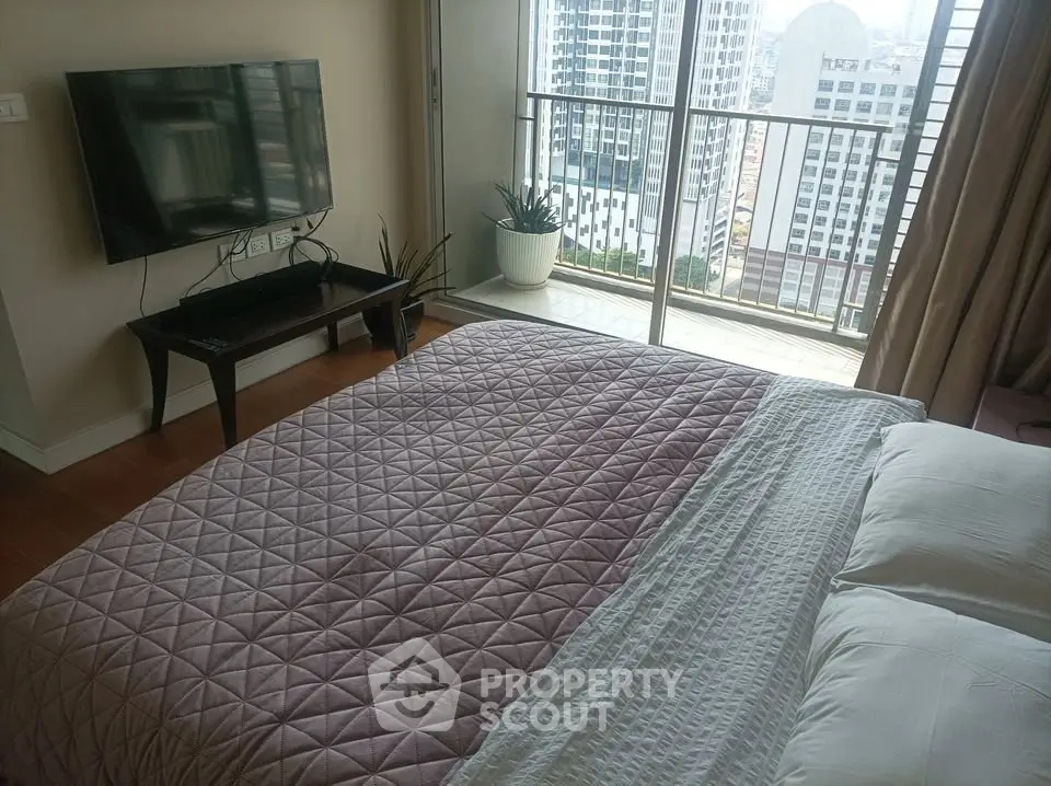 Modern bedroom with balcony view in high-rise apartment
