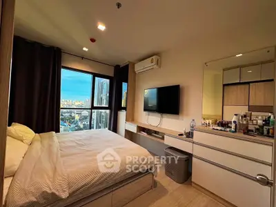 Modern bedroom with city view, featuring a wall-mounted TV and sleek storage solutions.