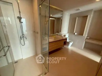 Spacious modern bathroom with glass shower and dual sinks
