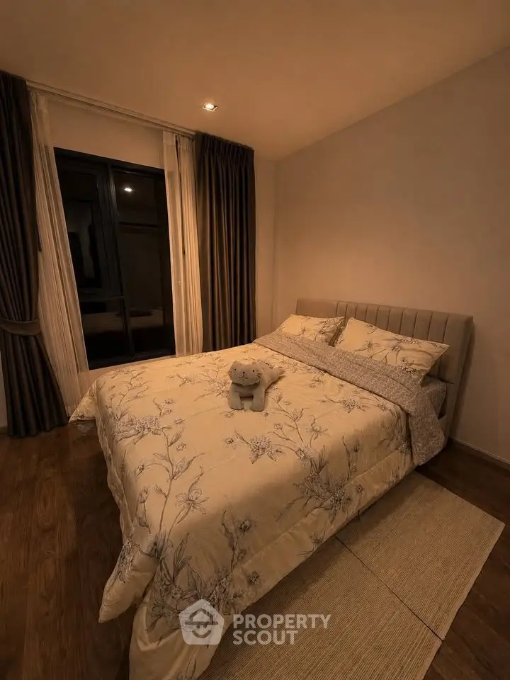 Cozy bedroom with elegant decor and plush bedding in modern apartment.
