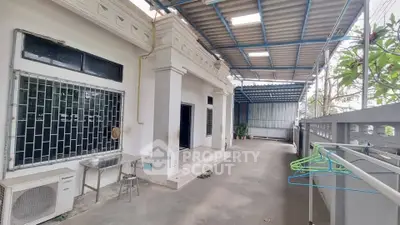 Spacious covered outdoor area with modern design and ample natural light, perfect for relaxation.
