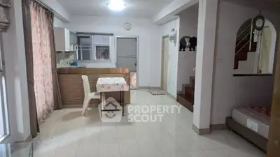 Spacious open-plan living area with dining space and staircase in modern home