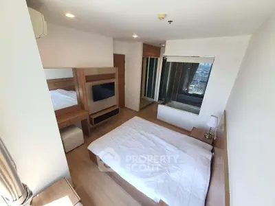 Modern bedroom with large window and wooden furniture in high-rise apartment