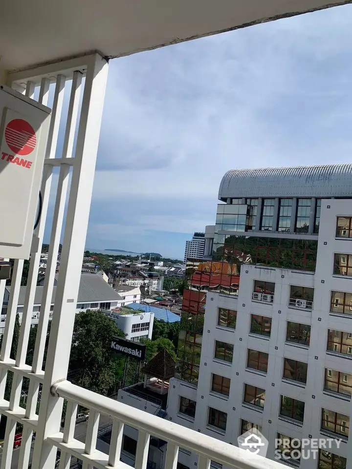 Stunning city view from a high-rise balcony with modern architecture and clear skies.