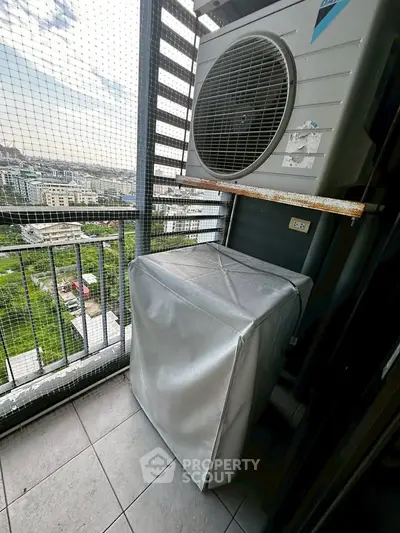 High-rise balcony with air conditioning unit and city view, perfect for urban living.