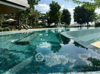 Luxurious outdoor pool with serene surroundings and lush greenery