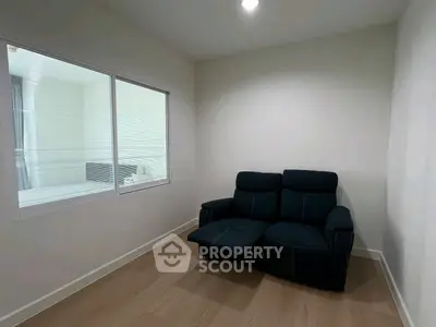 Cozy small room with a comfortable recliner sofa and wooden flooring