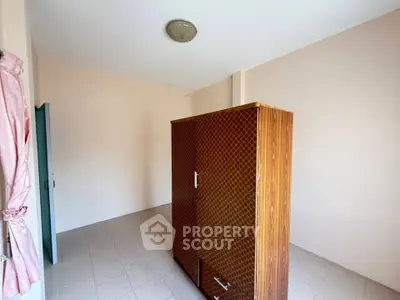 Spacious empty room with wardrobe and tiled floor, ready for customization.