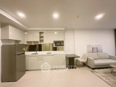 Modern open-layout kitchen with sleek cabinetry and cozy living area