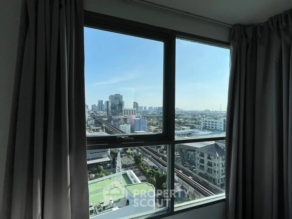 Stunning cityscape view from high-rise apartment window with modern skyline.