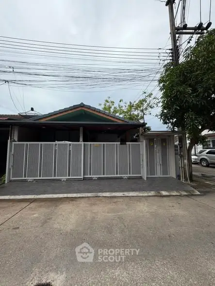 Charming single-story home with gated entrance and spacious driveway in a serene neighborhood.