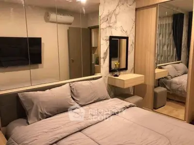 Modern bedroom with stylish decor and mirrored wardrobe