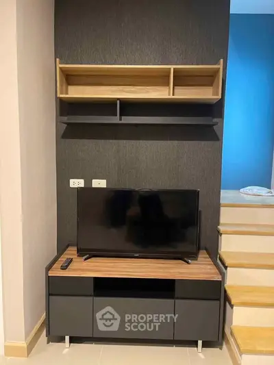 Modern living room with sleek TV stand and wall-mounted shelves