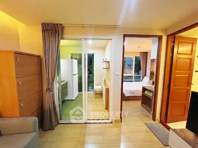 Cozy apartment interior with living room, bedroom, and kitchen area, featuring wooden flooring and modern furnishings.