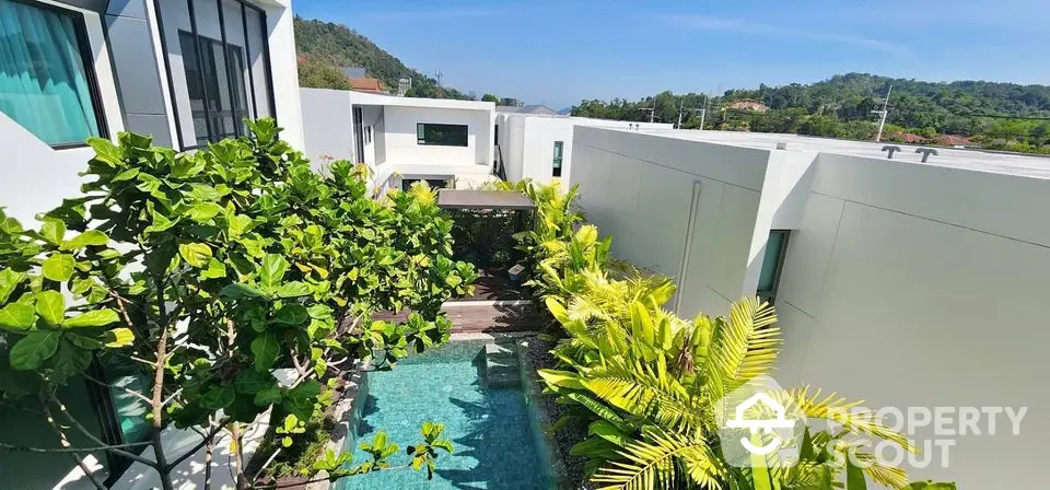 Luxurious modern villa with private pool and lush greenery, offering serene mountain views.