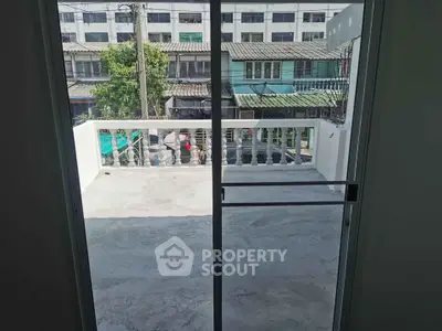 Spacious balcony with urban view, perfect for relaxation and outdoor activities.