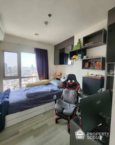 Modern urban bedroom with panoramic city views, featuring a comfortable bed, gaming chair, and ample shelving for personal items.