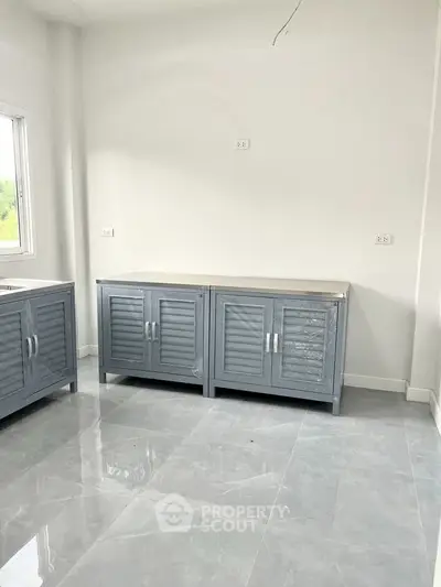 Modern kitchen with sleek cabinets and glossy tile flooring