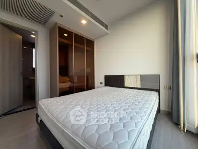 Modern bedroom with sleek design and ample natural light, featuring a comfortable mattress and stylish wardrobe.