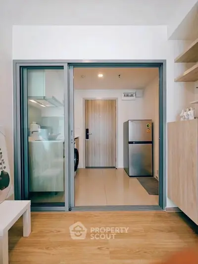 Modern kitchen with sliding glass door and compact appliances