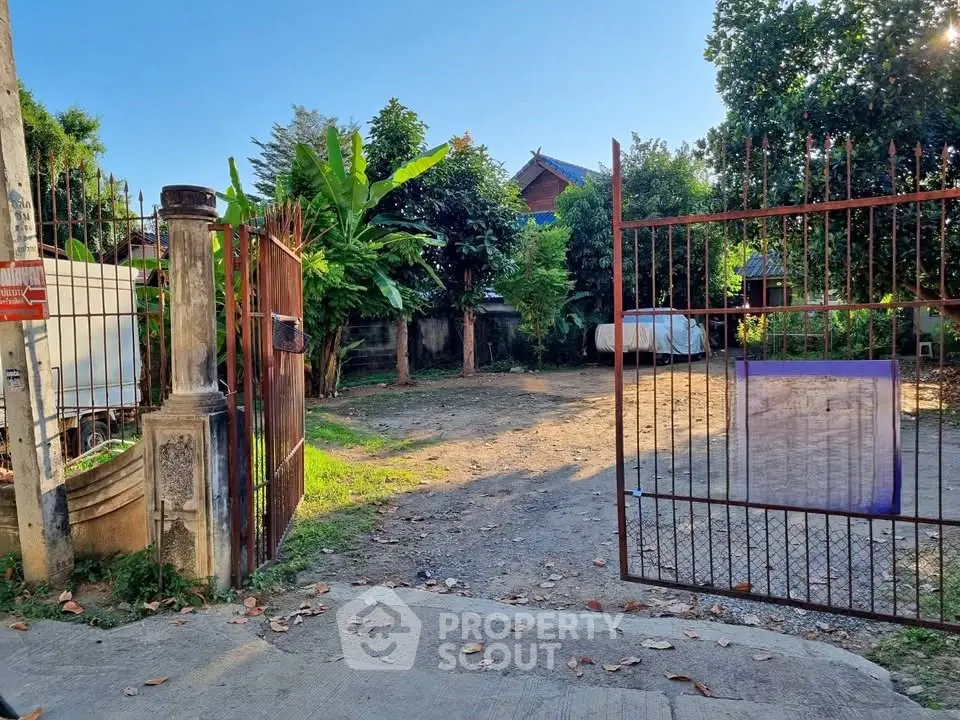 Spacious gated property with lush greenery and ample parking space, perfect for development opportunities.