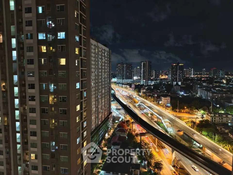 Stunning night view of cityscape from high-rise building, showcasing vibrant urban lights and modern architecture.