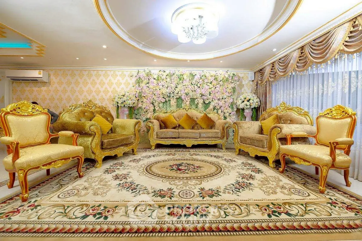 Luxurious living room with ornate gold furniture and floral decor