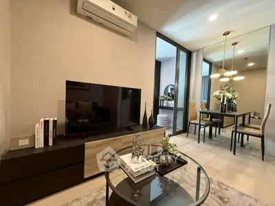 Modern living room with sleek furniture and dining area, featuring a large TV and elegant decor.