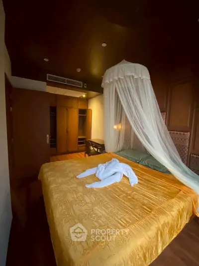 Luxurious bedroom with elegant canopy bed and warm lighting, perfect for relaxation and comfort.