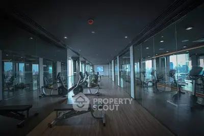 Luxurious high-rise gym with panoramic city views and modern fitness equipment.