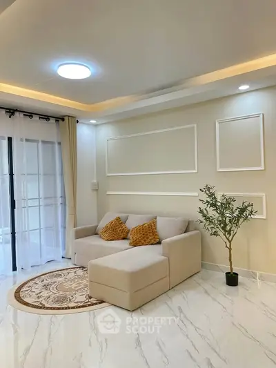 Elegant living room with modern decor, cozy sofa, and stylish lighting in a bright, inviting space.