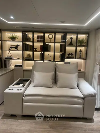 Luxurious living room with elegant sofa and stylish backlit shelving, perfect for modern living.