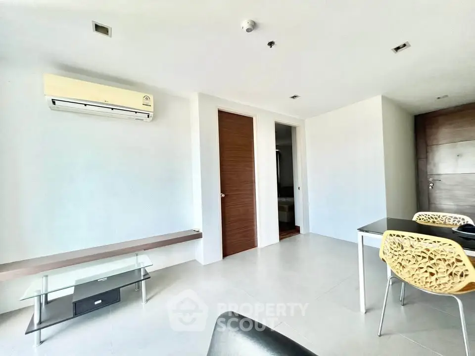 Modern minimalist living room with air conditioning and stylish furniture.