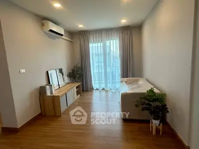 Modern living room with wooden flooring and natural light