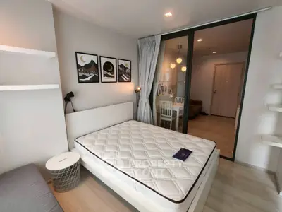 Modern bedroom with stylish decor and glass partition in a cozy apartment.