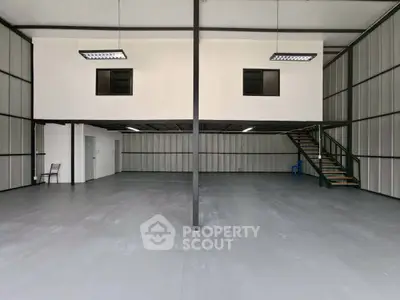 Spacious industrial warehouse with mezzanine and modern lighting