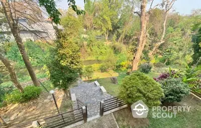 Stunning garden view from balcony with lush greenery and stone pathway