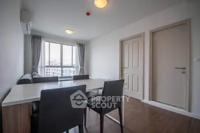 Modern living room with dining area and large window in a stylish apartment
