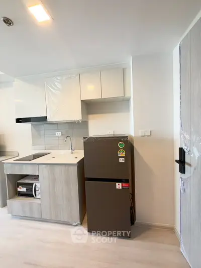 Modern kitchen with sleek cabinetry and appliances in a stylish apartment