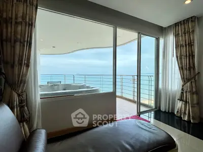 Luxurious oceanfront living room with stunning sea view and private balcony.