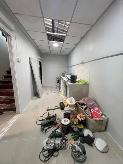 Under-construction utility room with tools and appliances