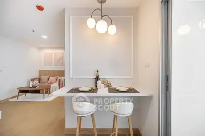 Modern open-plan living and dining area with stylish decor and lighting