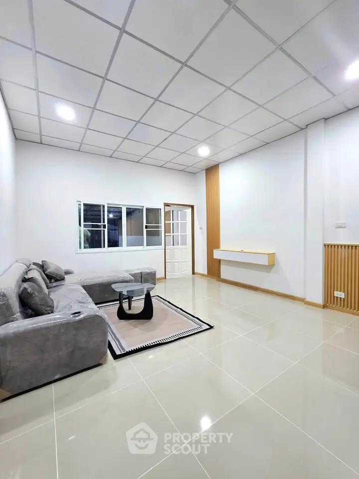 Spacious modern living room with sleek design and cozy seating area.