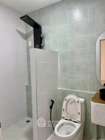 Modern bathroom with sleek shower and stylish vanity in contemporary apartment.