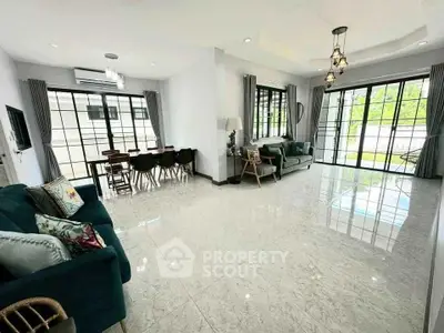 Spacious living room with elegant decor and large windows for natural light