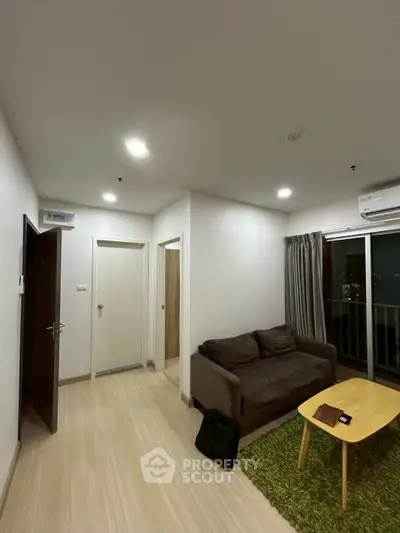 Modern living room with cozy sofa and balcony view in stylish apartment
